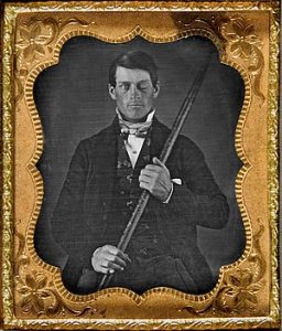 This image shows Phineas Gage sitting for his photo to be taken while holding his tamping iron around the time of 1849.
