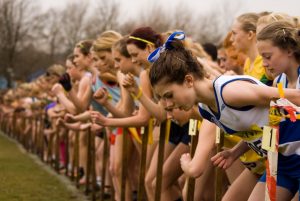 This image shows a long line of young women lined up preparing to start a running race.