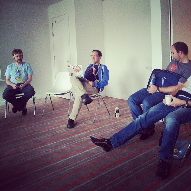 This is a color image of four adults sitting in a circle while participating in a meeting.