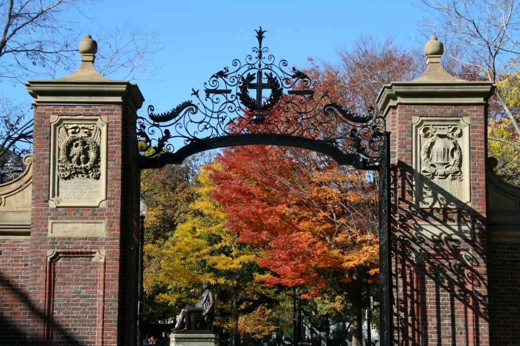 This is a color image of the gates of Harvard University during the fall.