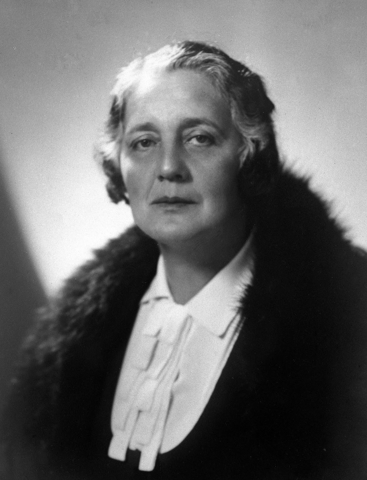 This is a black and white photograph taken of Melanie Klein in 1927. She is wearing a white and black top, and she is looking directly at the camera.