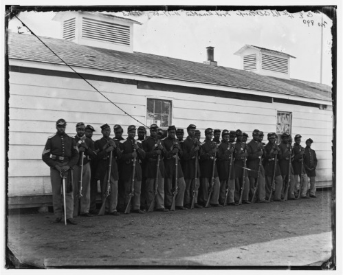 A photograph of a regiment of African American Union soldiers standing in front of a building.