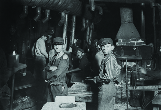 A photographer took this image of children working in a New York glass factory at midnight. There, as in countless other factories around the country, children worked around the clock in difficult and dangerous conditions.