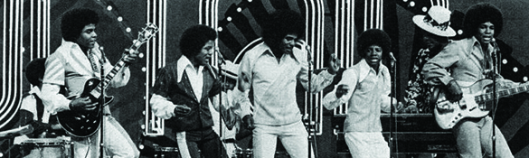 black and white image of the jackson 5 performing with each member sporting a large afro