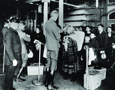 This photo shows newly arrived immigrants at Ellis Island in New York. Inspectors are examining them for contagious health problems, which could require them to be sent back. (credit: NIAID)