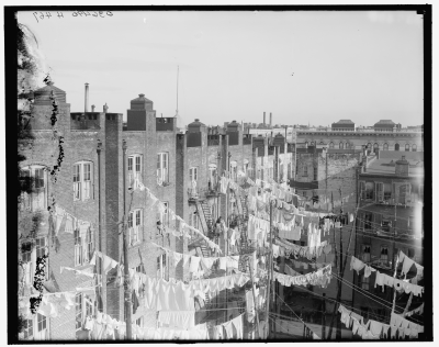 Tenement buildings with laundry drying, New York City, 1900 - 1910.